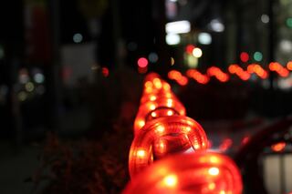 Red lights glowing and reflected in a dark window